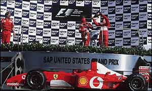 Michael Schumacher and Rubens Barrichello celebrate on the podium of the US Grand Prix