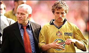 Reid helps his players off the field after their 1998 play-off final defeat at the hands of Charlton