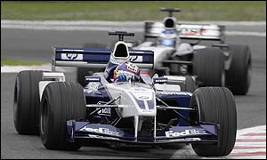 Juan-Pablo Montoya of Williams enters a corner ahead of McLaren's Kimi Raikkonen 