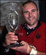 Llanelli captain Scott Quinnell lifts the Welsh/Scottish League trophy