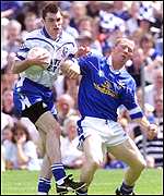 Jason O'Reilly (right) in action against Monaghan's Gary McQuaid