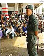 A security officer and illegal immigrants in southern Malaysia