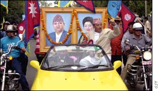 President of the Nepal Patriotic Organisation Prakash Gurung (C) show support for King Gyanendra