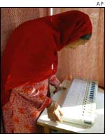 A Indian voter looks at the electronic voting machine trying to figure out how to cast her vote 