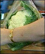 A cauliflower is checked through a till