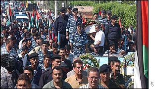 Mourners accompany the coffin of Col. Rajeh Abu Lehiya