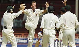 Shane Warne takes a wicket in Sharjah