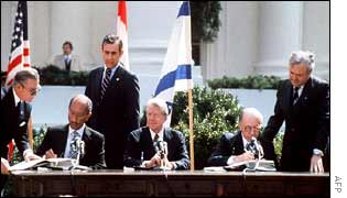 Egyptian President Anwar Sadat (L) and Israeli Prime Minister Menachem Begin (R), seated next to Carter