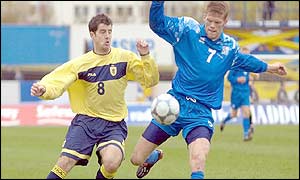 Scotland's Stephen Crawford hussles for the ball