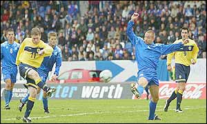 Gary Naysmith volleys the ball past the floundering Iceland defence