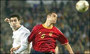 Winger Keith Gillespie tries to win the ball from Spain's Carles Puyol 