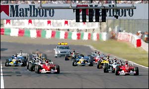 Ferrari's two cars head the field on the starting grid