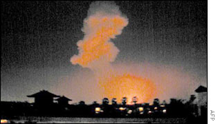 The blast's flames and smoke from a distance