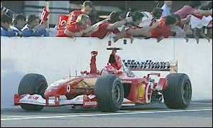 Michael Schumacher salutes the crowd after victory