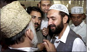 Mian Aslam, right, a candidate of a religious alliance of Islamic parties meets supporters in Islamabad