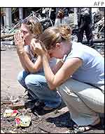 Two Canadian tourists lay flowers at the scene