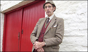 John Morgan stands outside a barn