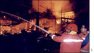 Firemen try to put out the flames at the Sari nightclub on Kuta Beach, on the island of Bali, Indonesia, early Sunday morning, 13 October 2002.