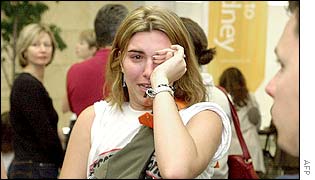 Jamie Brendt who was in the Sari Bar at the time of a huge bomb blast in Bali arrives at Sydney International Airport to be greeted by families and friends 14 October 2002