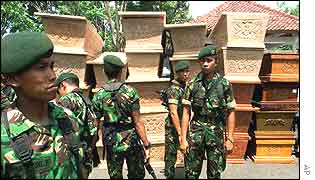 Indonesian soldiers in front of empty coffins outside a hospital in Denpasar, Bali