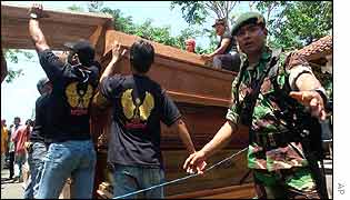 Rescue workers prepare coffins for victims at a hospital in Bali 