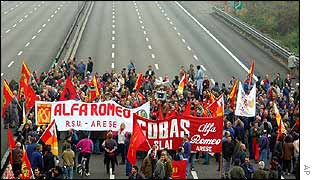 Workers block a motorway near the Alfa Romeo factory in Arese, near Milan