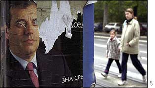 People pass people poster of Vojislav Kostunica