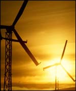 Wind turbines against golden sky 