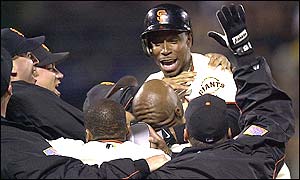 Match-winner Kenny Lofton is swamped by team-mates