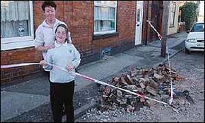 A mother and daughter survey their smashed chimney in Bloxwich after the earthquake