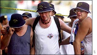 Australian tourists weep as they leave the site of a bomb blast which killed friends and relatives after laying wreaths at the site 15 Oct 2002