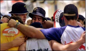Australian tourists hug each other