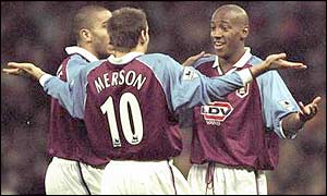Villa team-mates Stan Collymore and Paul Merson congratulate Dion Dublin after another strike