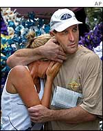 Stuart Cram comforts his sister Tia Byron, who lost her 14-year-old daughter Chloe in the bombing