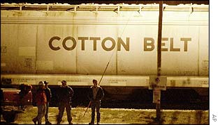 Workers stand near a rail car at Denison, Iowa 