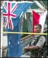 A Balinese policeman next to an Australian flag