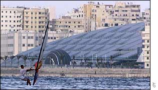 A windsurfer sails past the new Alexandria library