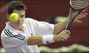 Tim Henman responds to Srichaphan with a high backhand return