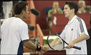 Paradorn Srichaphan is congratulated by Tim Henman after beating the British number one in three sets