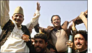 Qazi Mohammad Afzal, left, celebrates his victory with supporters