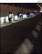 Palestinian workers prepare to cross into Israel