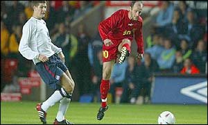 Steven Gerrard can only watch as Vanco Trajanov sweeps the ball into England's net