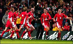Wales' players celebrate a famous 2-1 victory over Italy