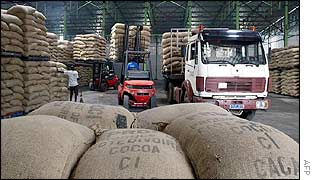 Workers load cocoa bags at a warehouse in the Abidjan port