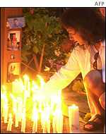 Candles are lit for victims of the bomb at a memorial service in Bali