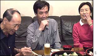 Kaoru Hasuike (right) chats with his father, Hidekazu, during a sushi dinner