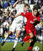Milan Baros of Liverpool gets past Stephen McPhail of Leeds 