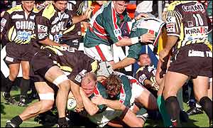 Leicester Tigers' Neil Back (centre) forces his way over the line to score a try