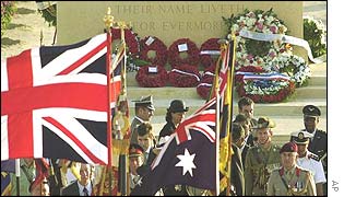 The British flag waves as state representatives leave the cemetery following a wreath-laying ceremony 