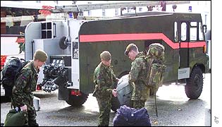 British soldiers in front of a Green Goddess fire engine
